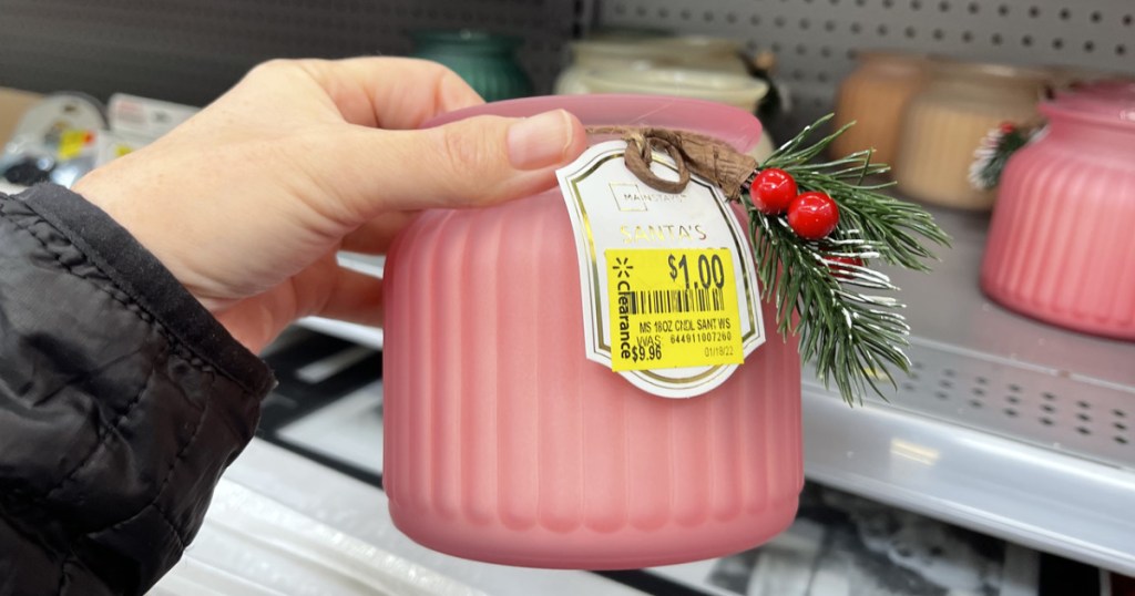 woman holding a pink jar candle 