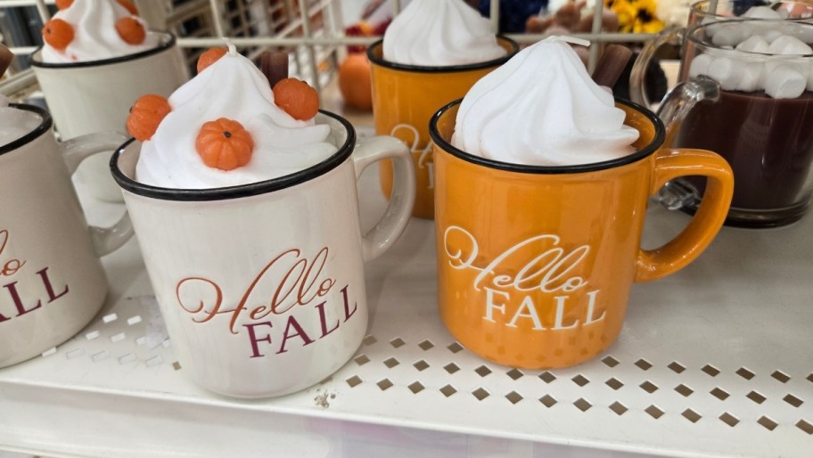 two fall mug candles on a store shelf