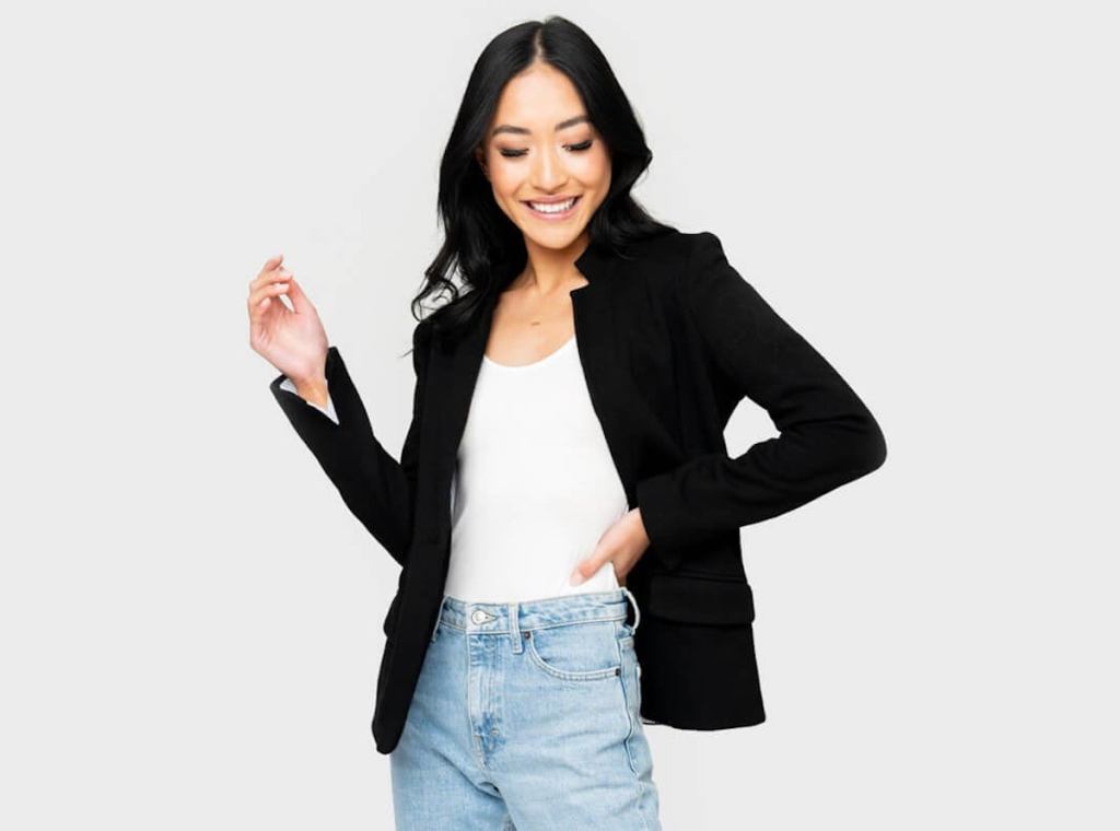 woman modeling black blazer with white shirt and jeans
