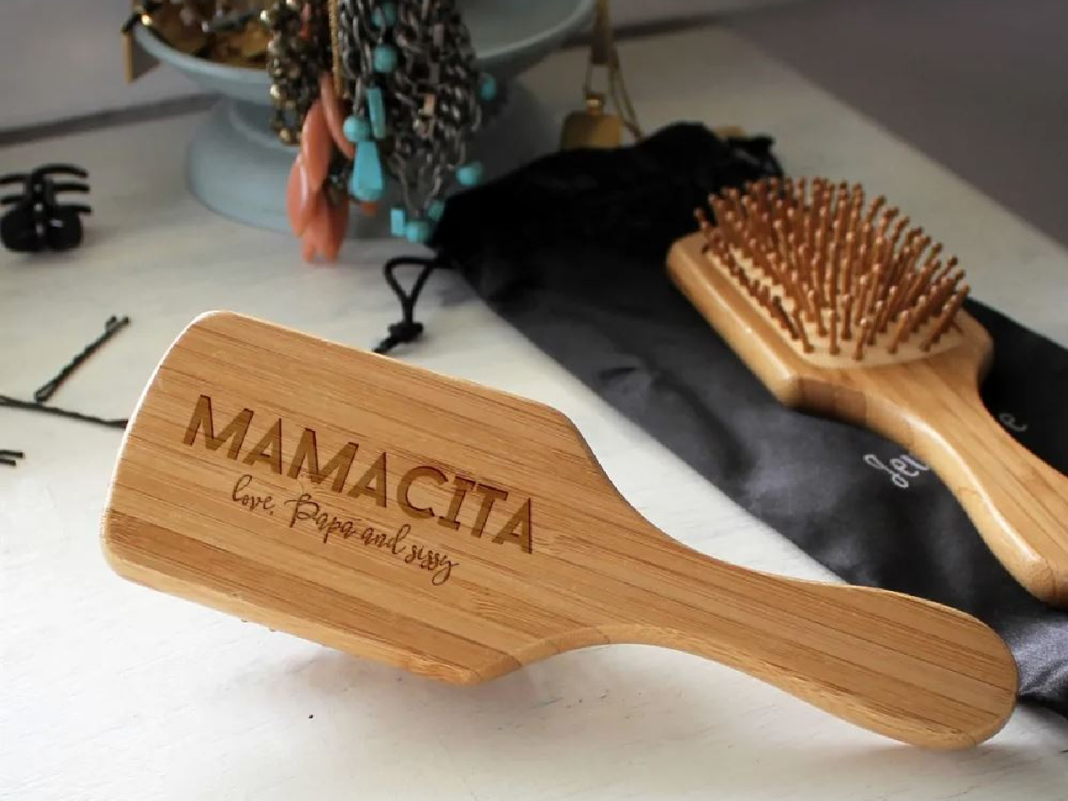 wooden hairbrush on counter with hair ties
