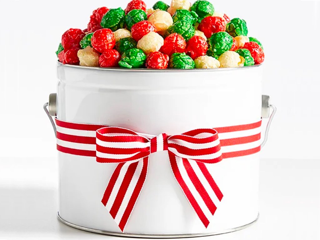 white popcorn pail full of red and green popcorn