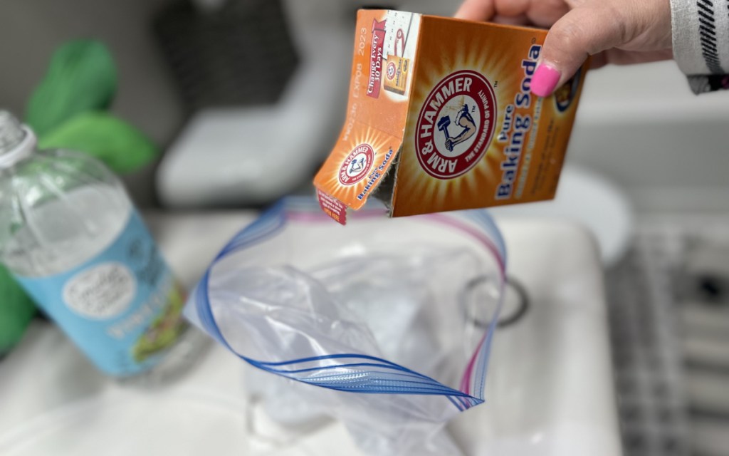 pouring baking soda with vinegar