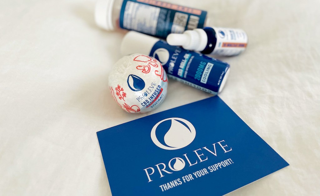 pile of proleve cbd products on white sheet with postcard