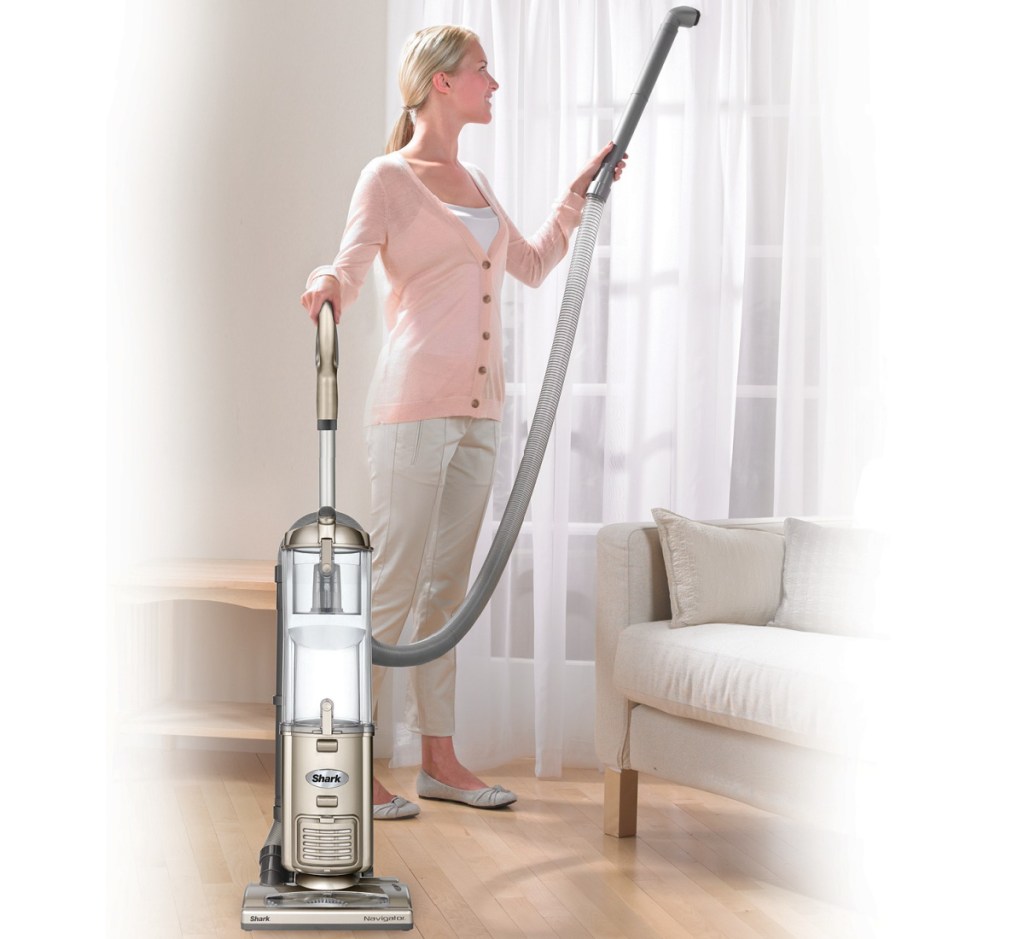 woman vacuuming curtains with shark vac