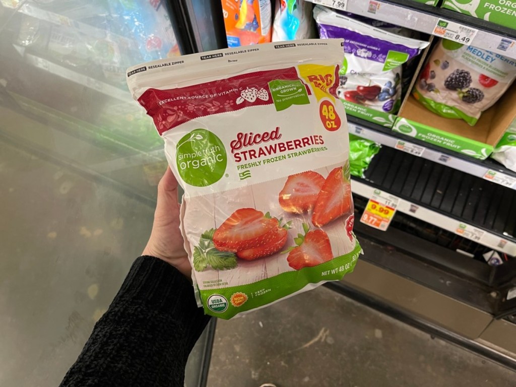 holding a bag of frozen organic strawberries