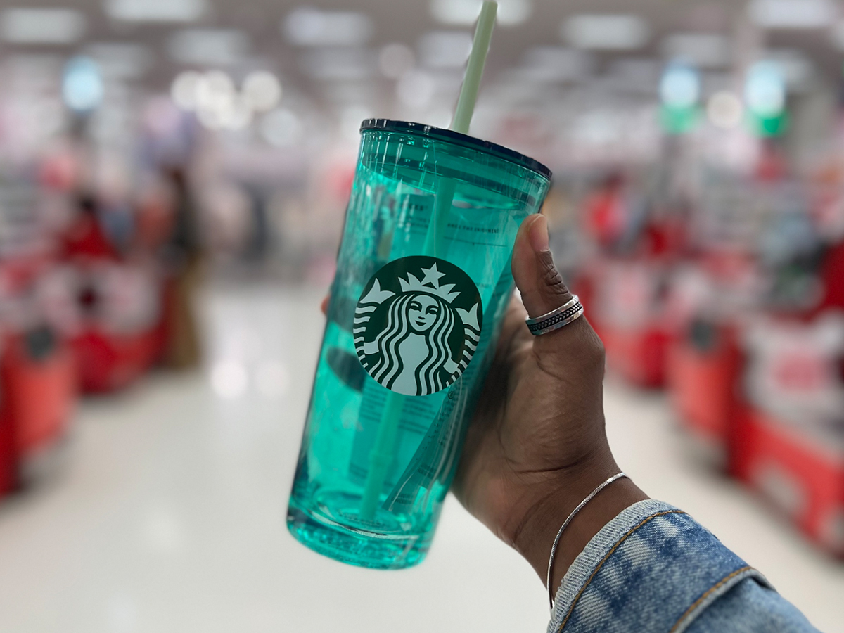 hand holding up a starbucks tumbler in store