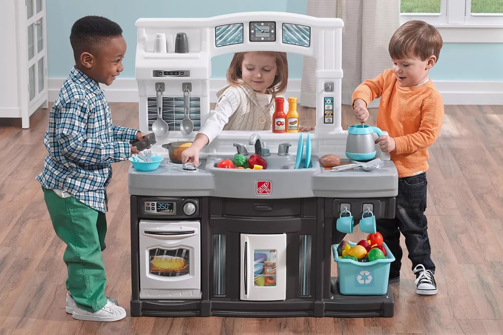 kids playing with a step2 modern cook kitchen