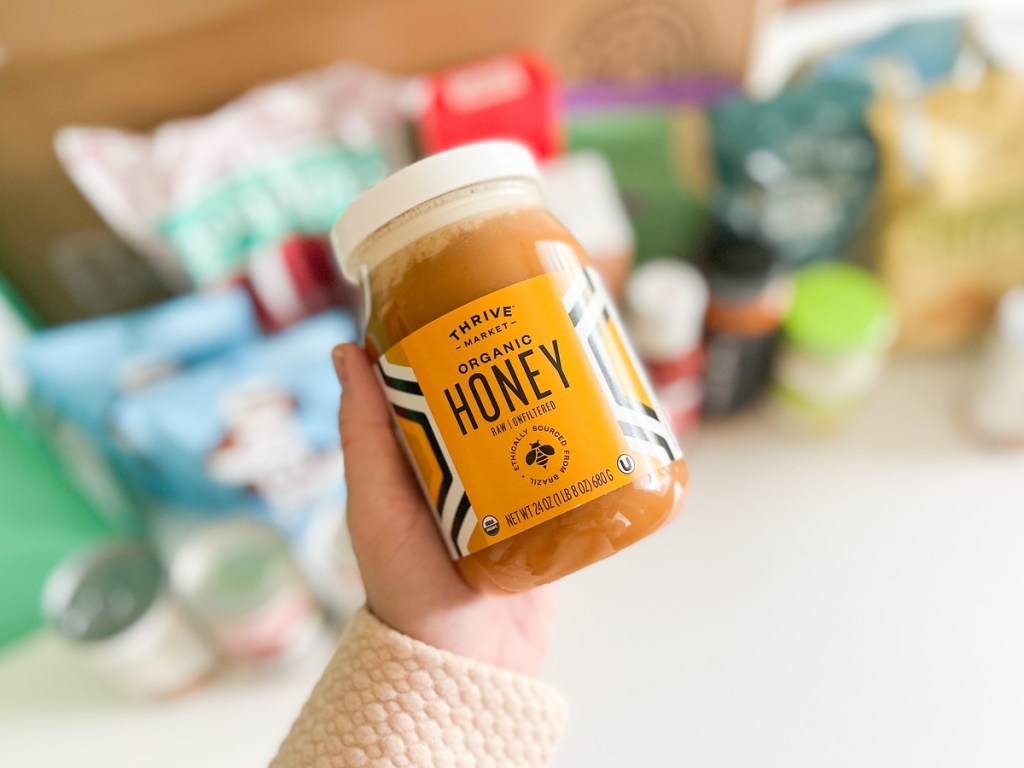 holding a jar of organic honey