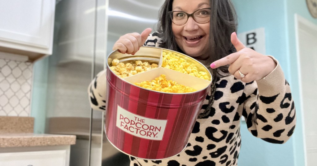 woman pointing at popcorn tin