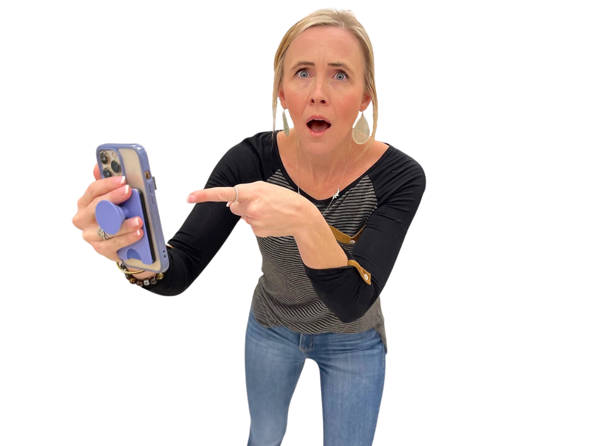 woman on white background holding phone and pointing to screen