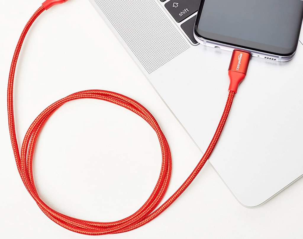 red charging cable plugged into computer and iphone