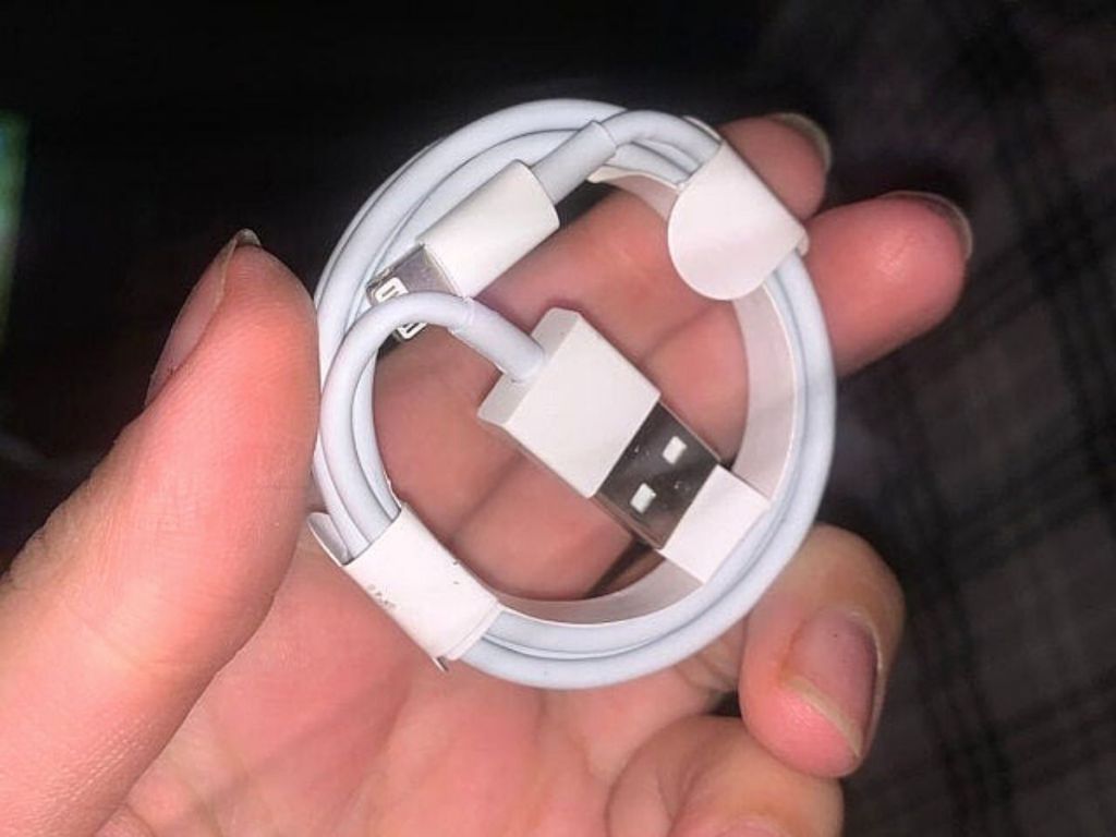 hand holding AmazonBasics USB-A to Lightning Charging Cable