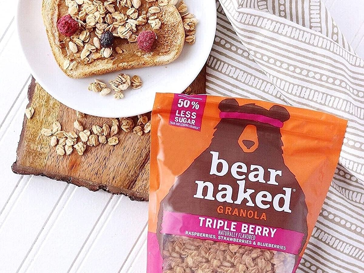 bag of triple berry Bear Naked Granola next to plate with toast and granola