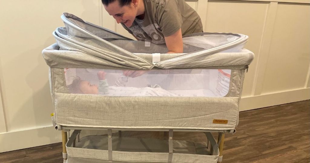 woman looking in a crib