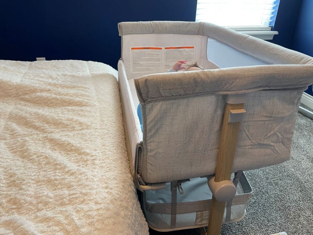 bassinet next to a bed