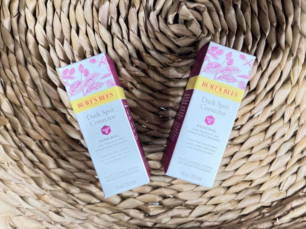 two boxes of Burt's Bees Dark Spot Corrector in a basket