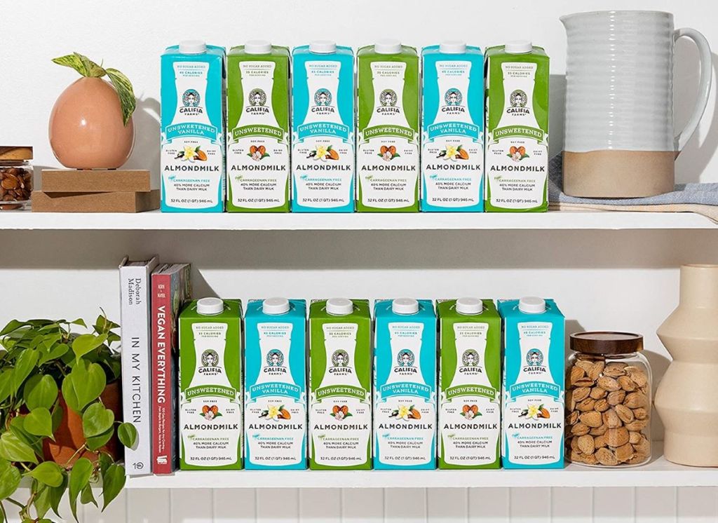 two shelves filled with almond milk