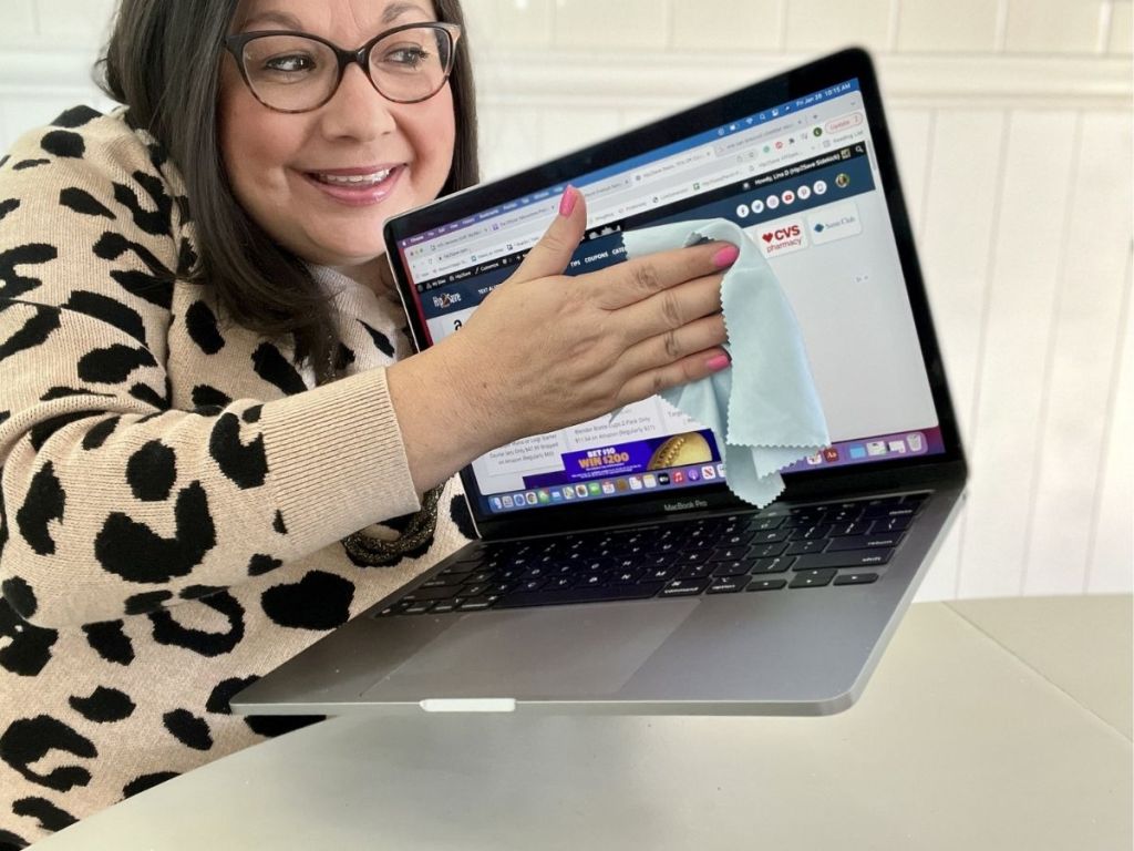 woman using Care Touch celaning cloth to clean laptop screen