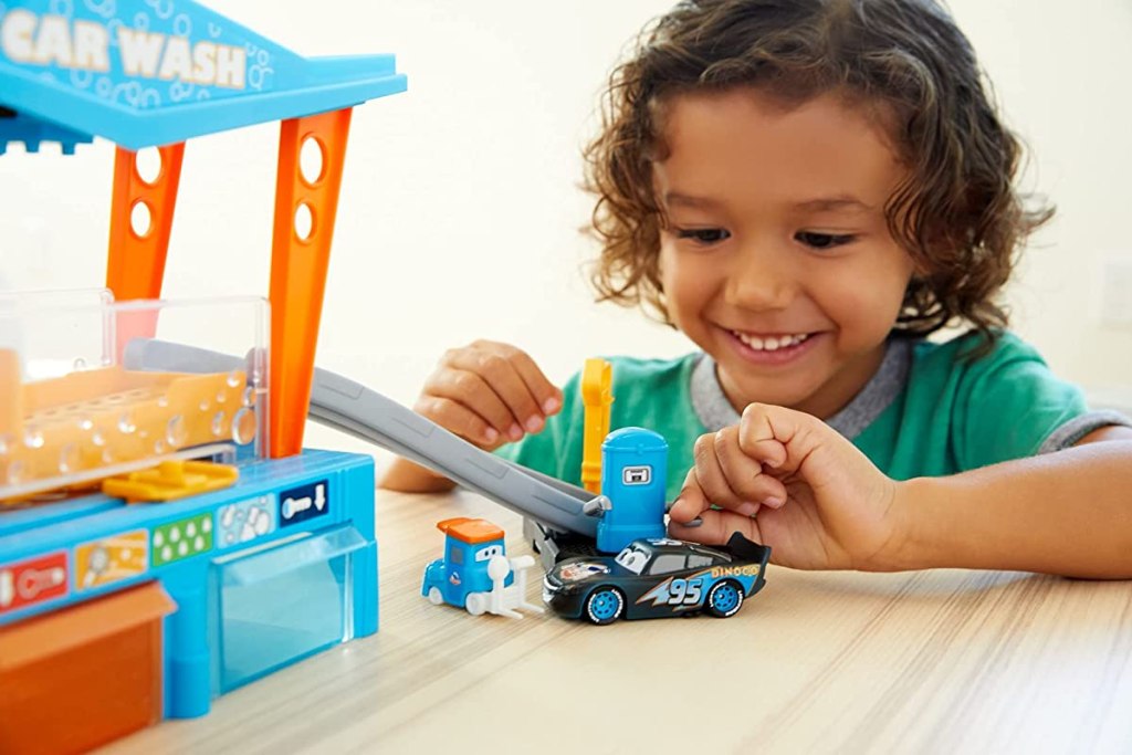 kid playing with a Cars toy set