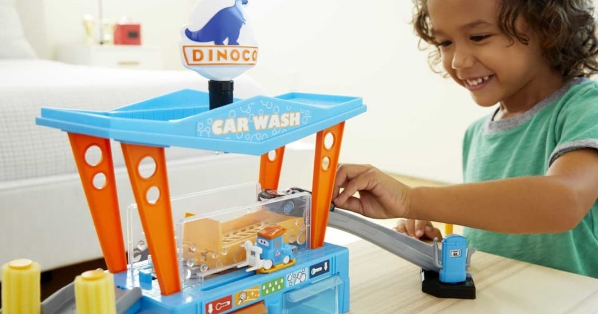 kid playing with a Dinoco Disney Pixar car wash playset