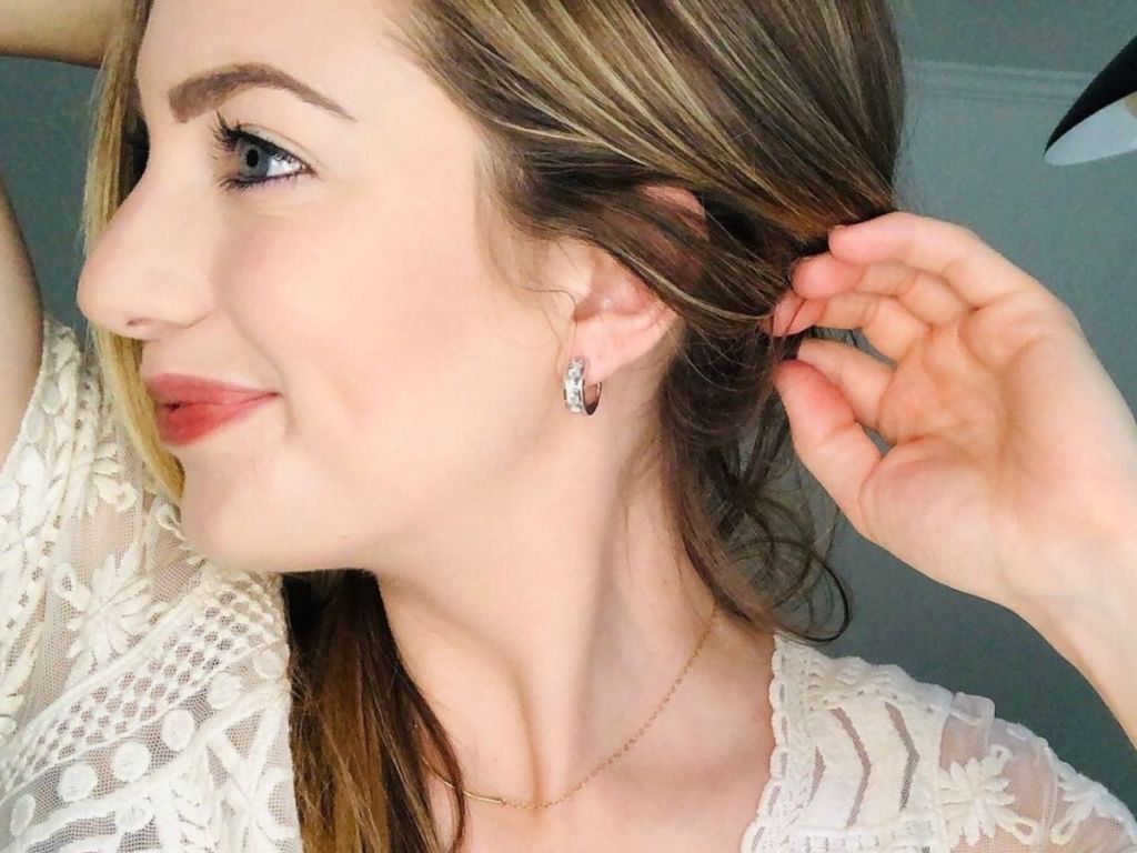woman showing off wide hoop earring in her ear