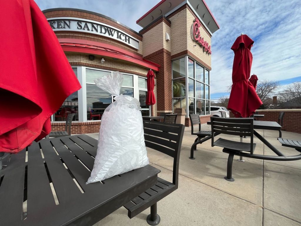 bag of ice on a table outside of Chick-fil-a