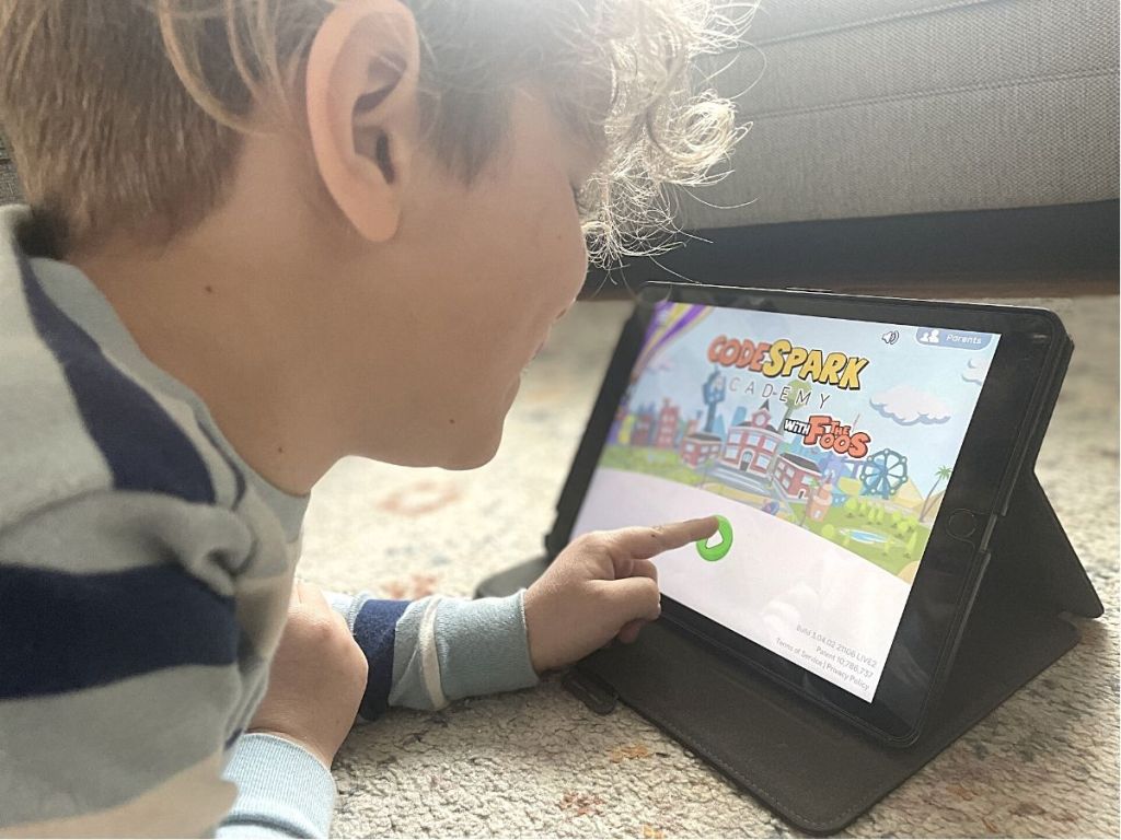 boy touching tablet with CodeSpark app