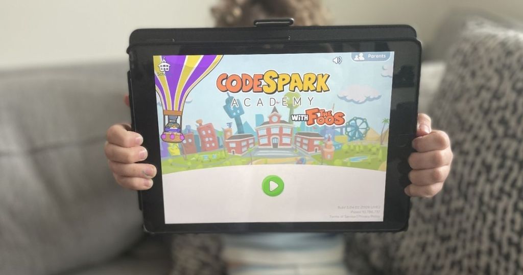 boy holding a tablet with Code Spark on it