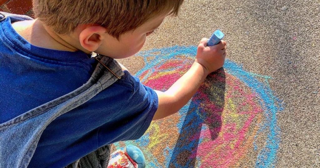 Little boy using Crayola Sidewalk Chalk