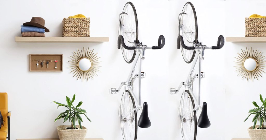 two bikes hanging on wall hooks