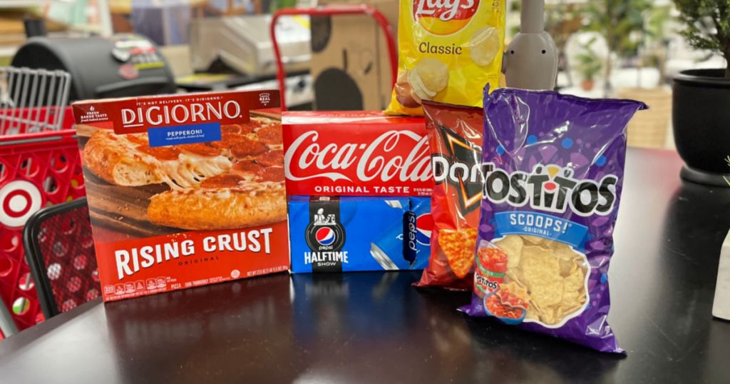 frozen pizza, soda and chips on counter 