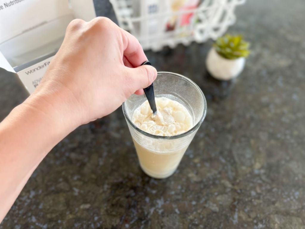 hand stirring a shake