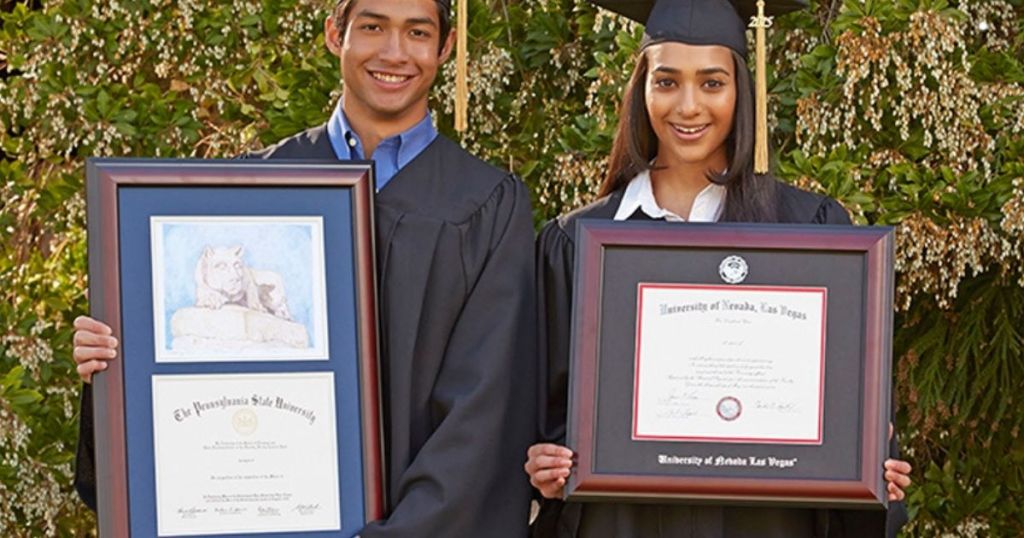 two people holding diploma frames
