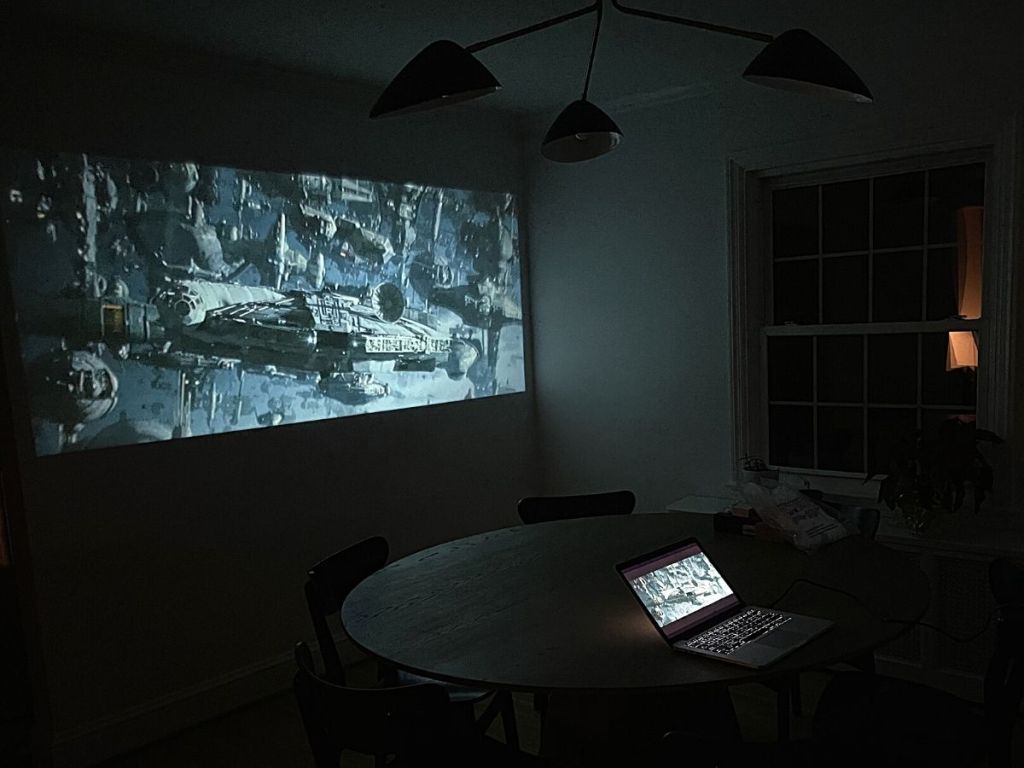laptop and projected movie on wall