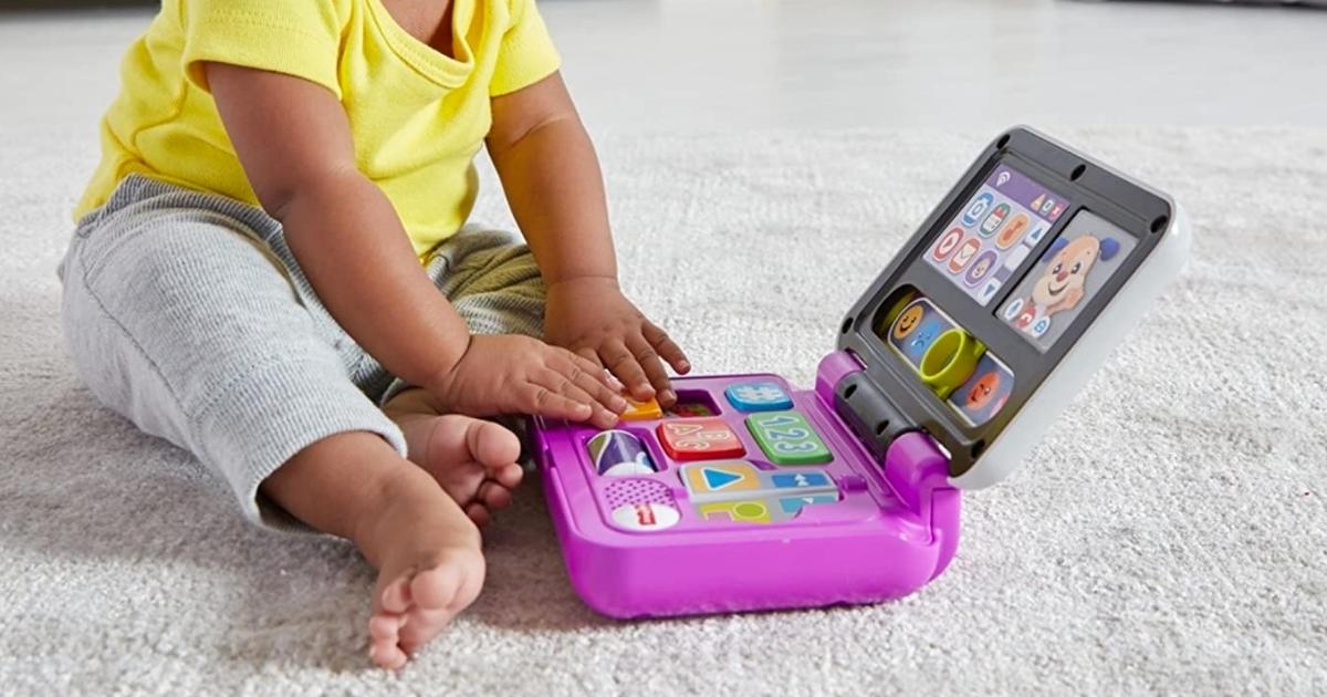baby girl playing with fisher-price click and learn laptop