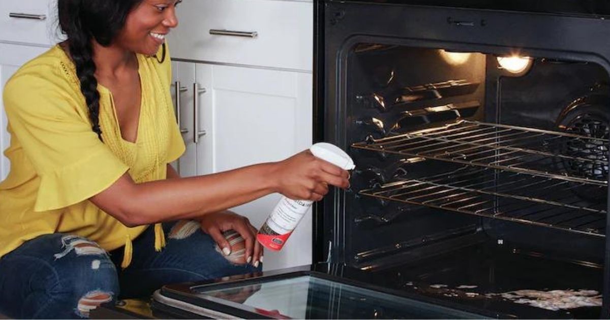 woman using Frigidaire Ready Clean Degreasing Oven & Microwave Cleaner on oven