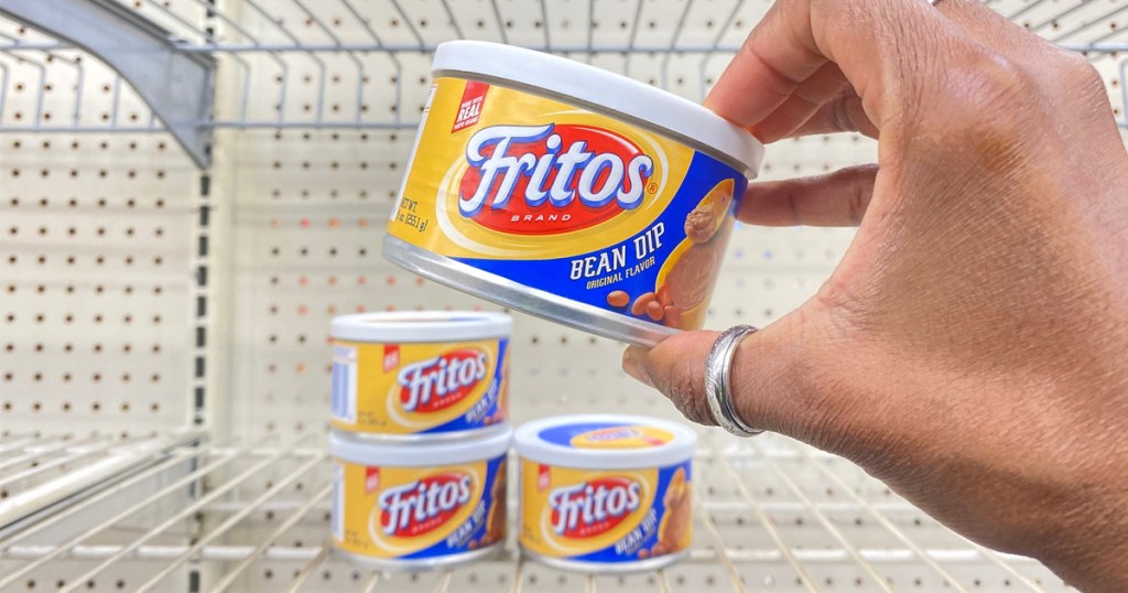 hand holding can of fritos bean dip