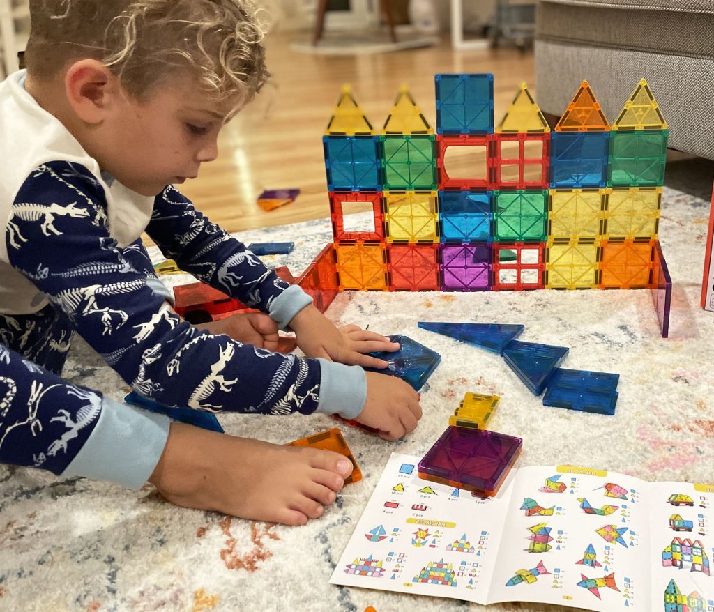 boy playing with magnetic tiles