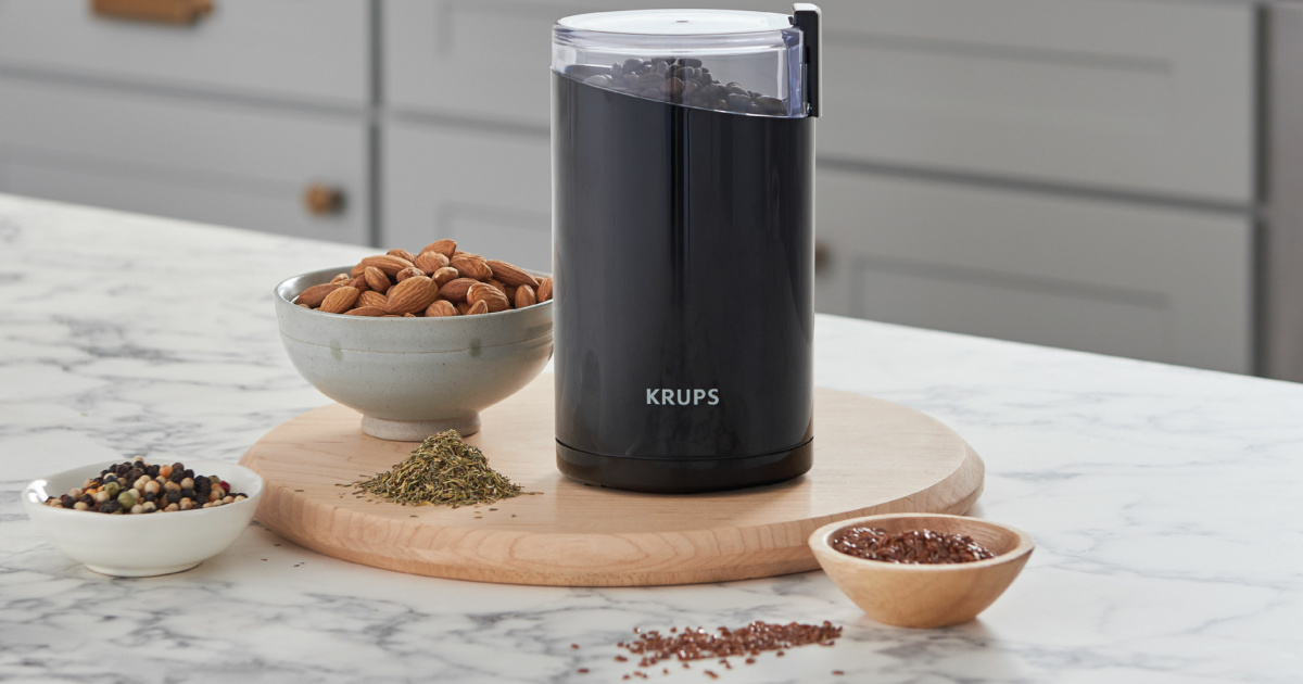 electric grinder and bowl of nuts and spices on kitchen counter