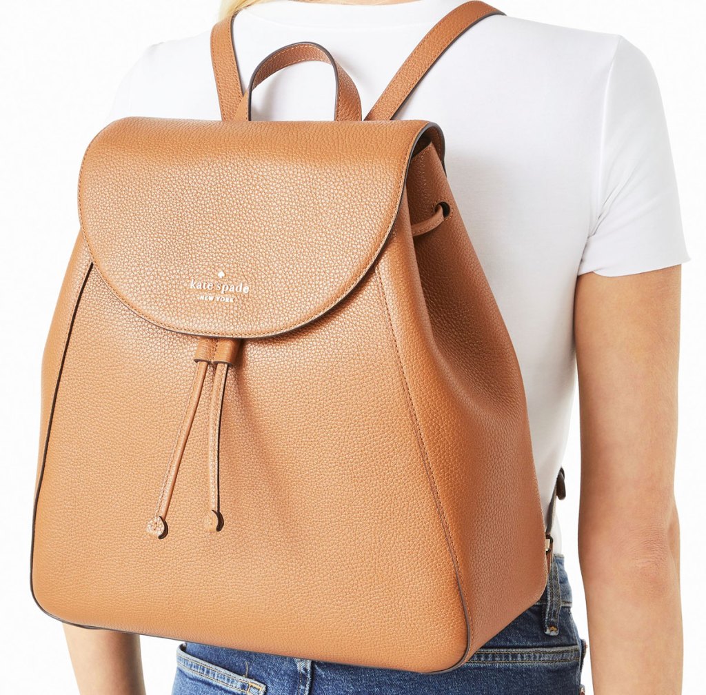 woman with large brown kate spade backpack