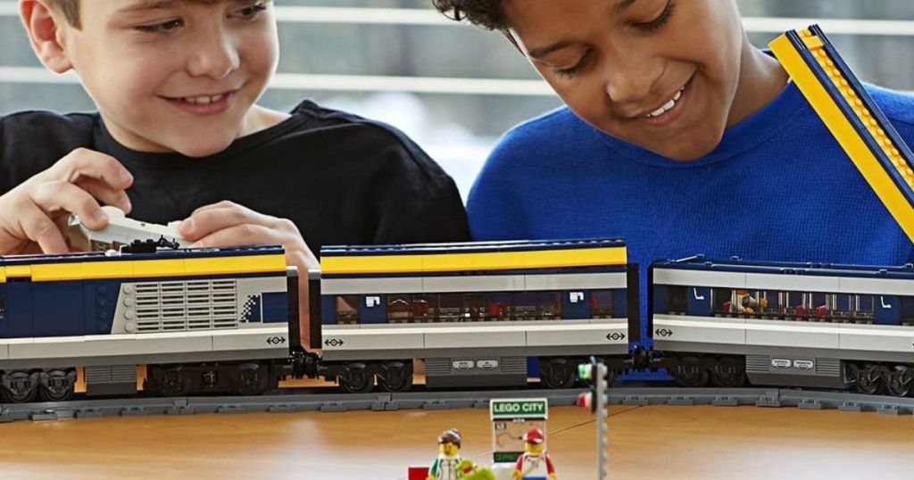 boys playing with a LEGO train