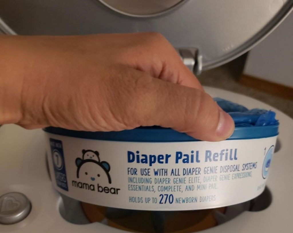 hand holding a diaper pail refill