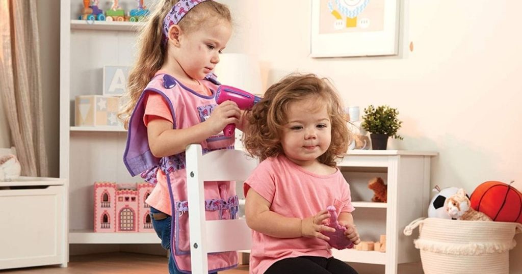 two little girls playing hairdresser