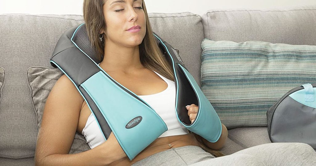 woman on couch wearing neck massager