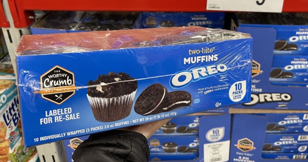 hand holding a box of OREO muffins