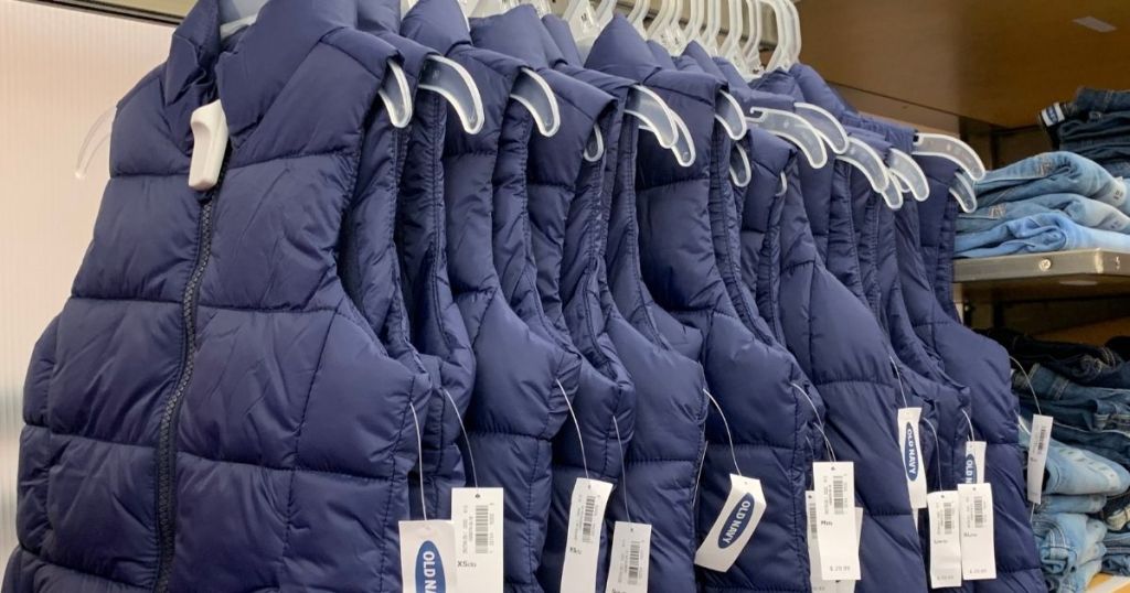 row of puffer vests on hangers at Old Navy