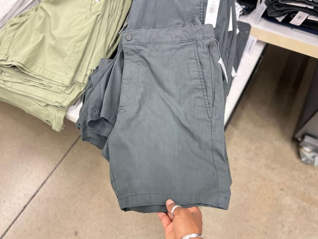 hand holding gray mens old navy shorts