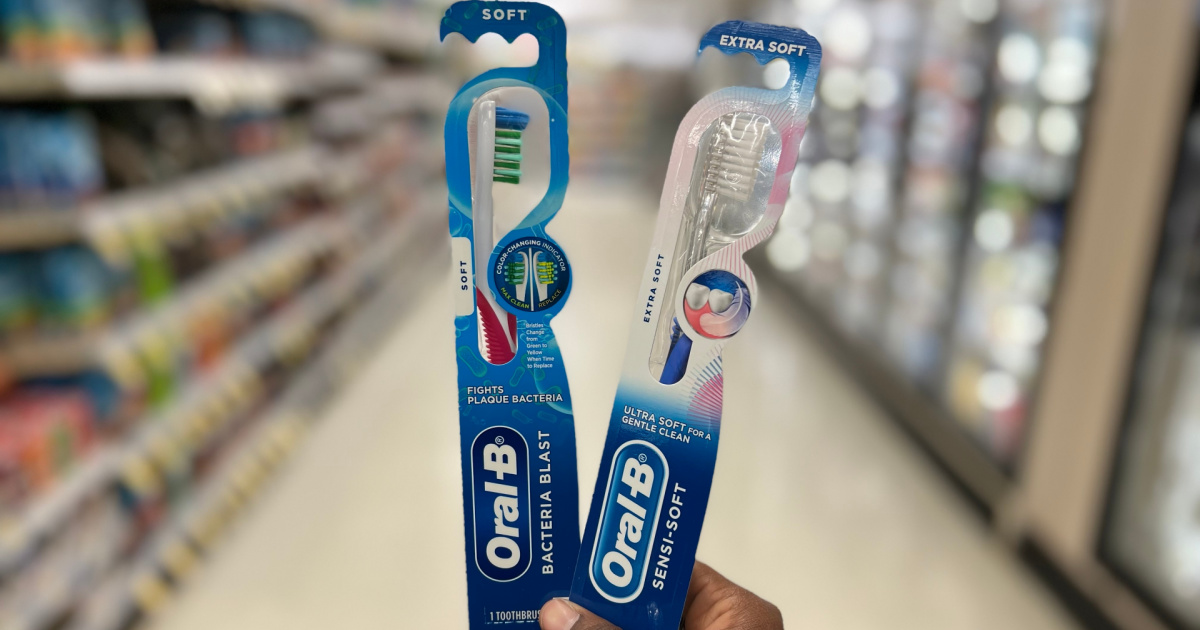 hand holding two toothbrushes in store