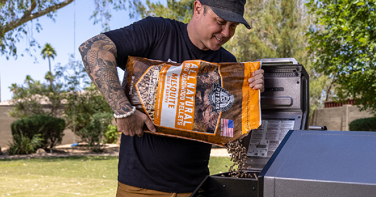man pouring wood pellets into outdoor grill