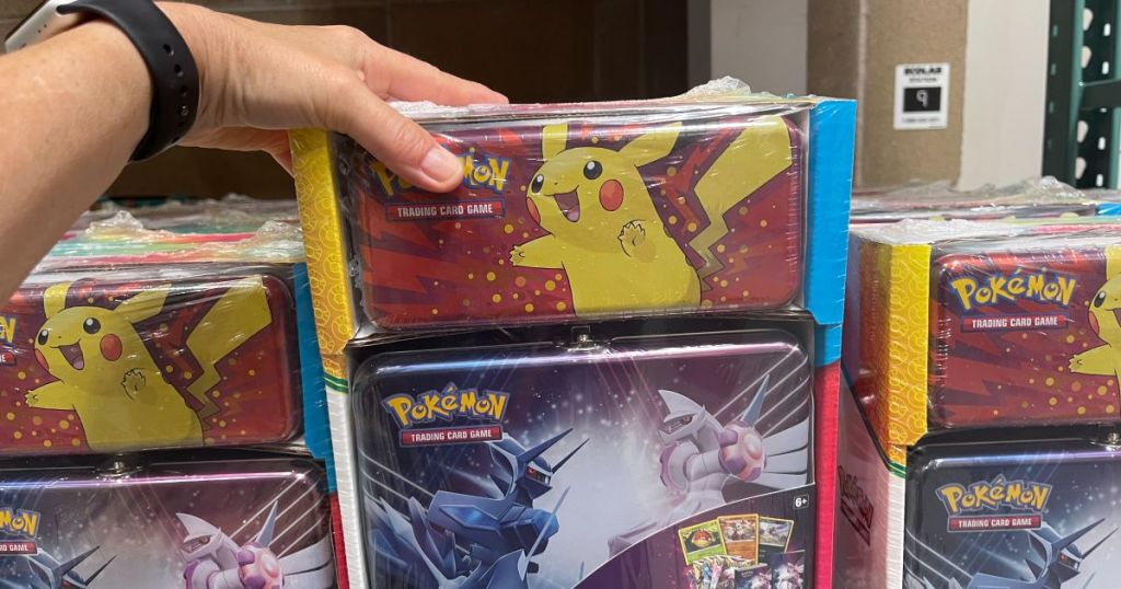 A hand holding Pokemon pencil box and collector's chest 